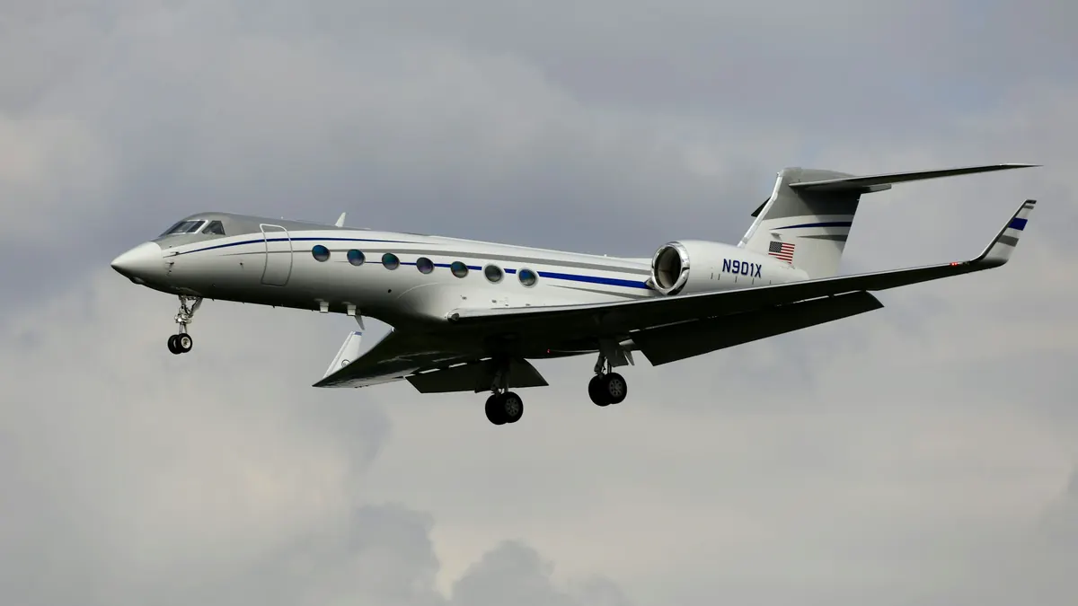 A business jet in flight above a layer of cloud